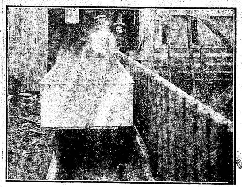 Showing galvanized tank and truck, in position for turning cooked feed into trough